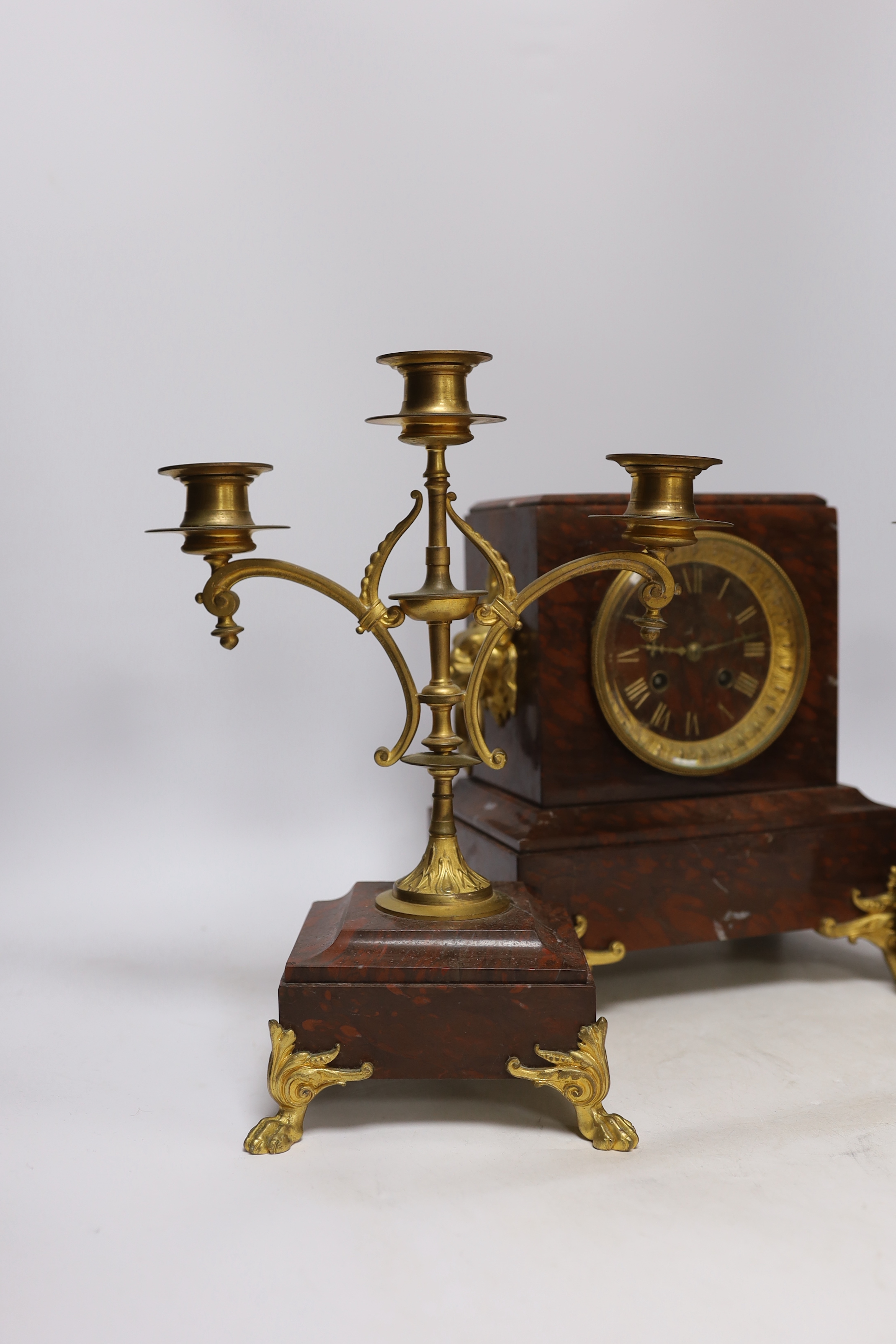 A late 19th century French rouge marble and ormolu clock garniture, 31cm